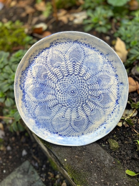 Handmade ceramic plate with intricate blue lace pattern