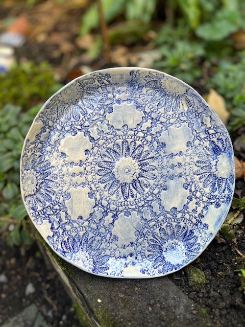 Handmade ceramic plate with intricate blue and white patterned design
